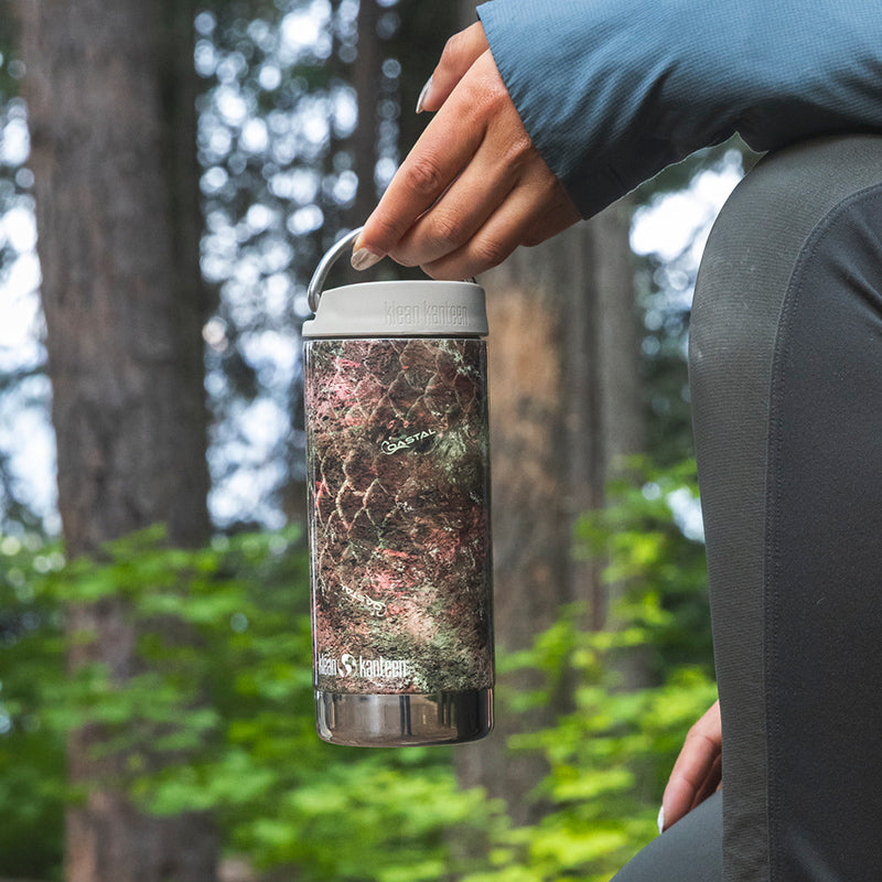 12oz-tkwide-with-twist-cap-mossy-oak-q1 12oz_tumbler_mossyoak_rainbowtrout_hand_closeup_square.jpg